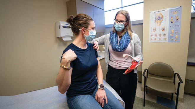 Dr. Jennifer Hopp, a board certified sports medicine physician, works with a patient. Hopp is the director of the Wentworth-Douglass Women's Sports Medicine Clinic.