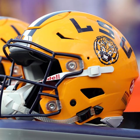 LSU football helmets on the sideline during a game
