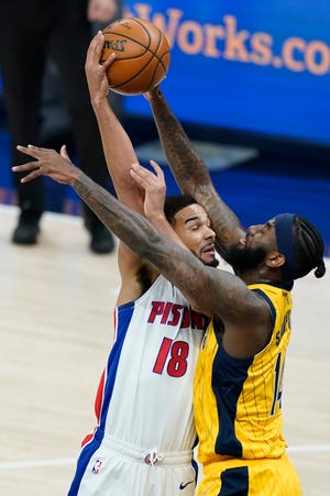 Detroit Pistons' Cory Joseph (18) makes a pass against Indiana Pacers' JaKarr Sampson (14) during the first half of an NBA basketball game, Saturday, April 24, 2021, in Indianapolis. (AP Photo/Darron Cummings)