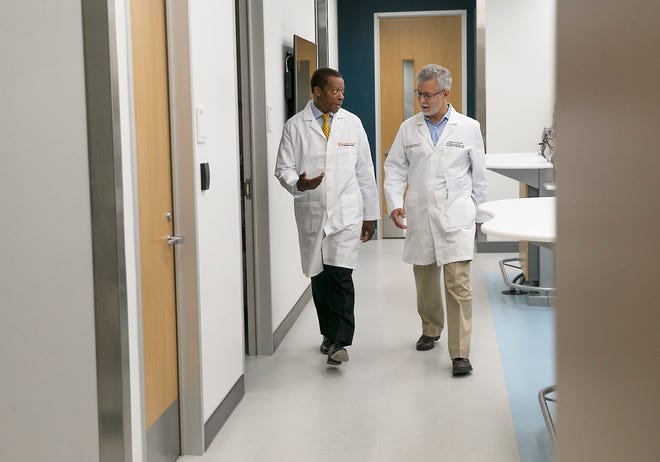Dr. C. Martin Harris, left, and Dr. Stuart Wolf of the University of Texas Dell Medical School are part of a new approach to medical care. The "360-degree care" model will be the focus of a study on health outcomes.