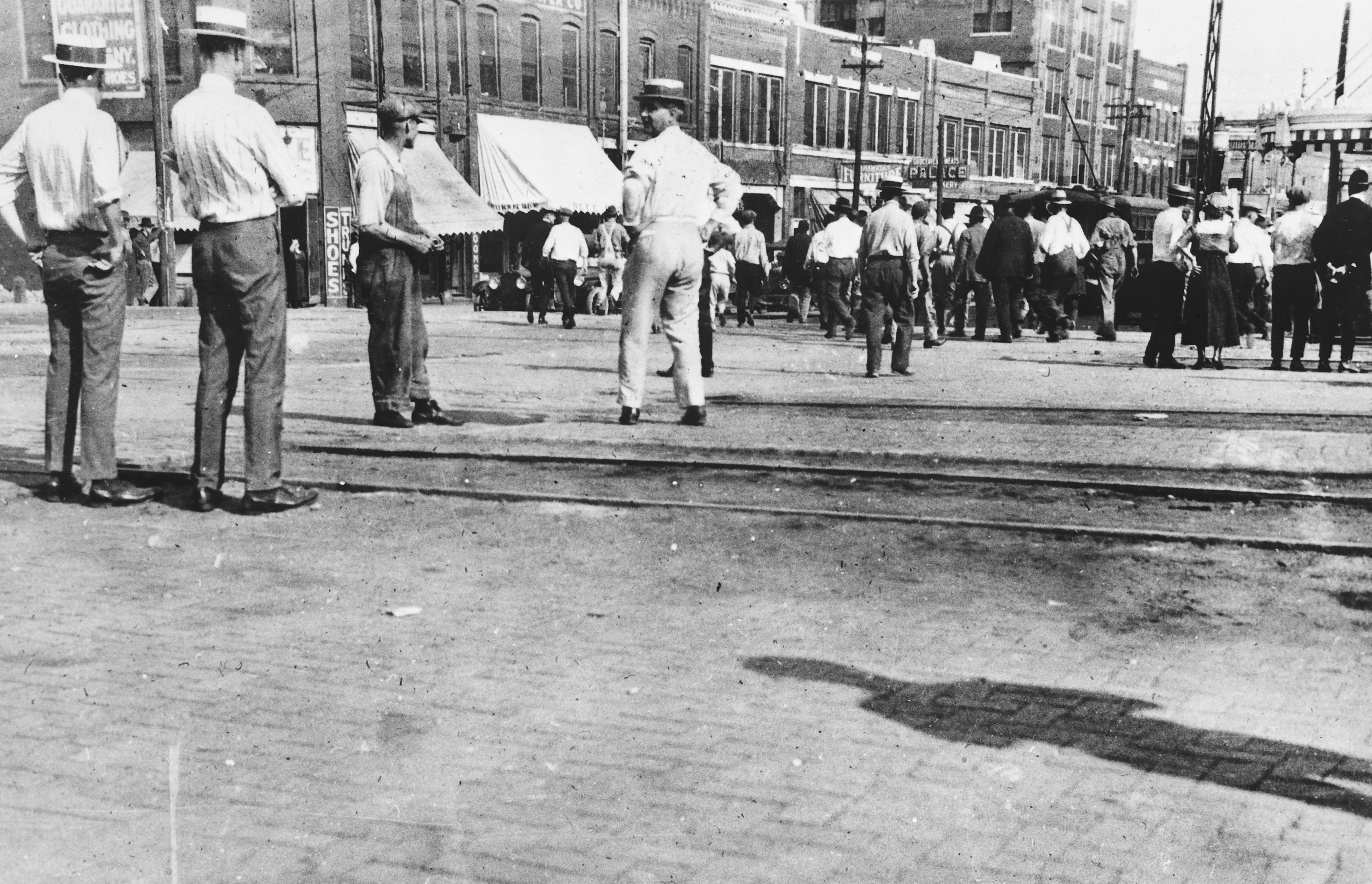 People stand in the street during the Tulsa race massacre.