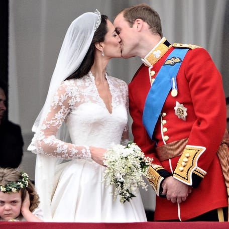 Britain's Prince William kisses his wife Kate, Duchess of Cambridge, on the balcony of Buckingham Palace, after their wedding service, on April 29, 2011, in London.