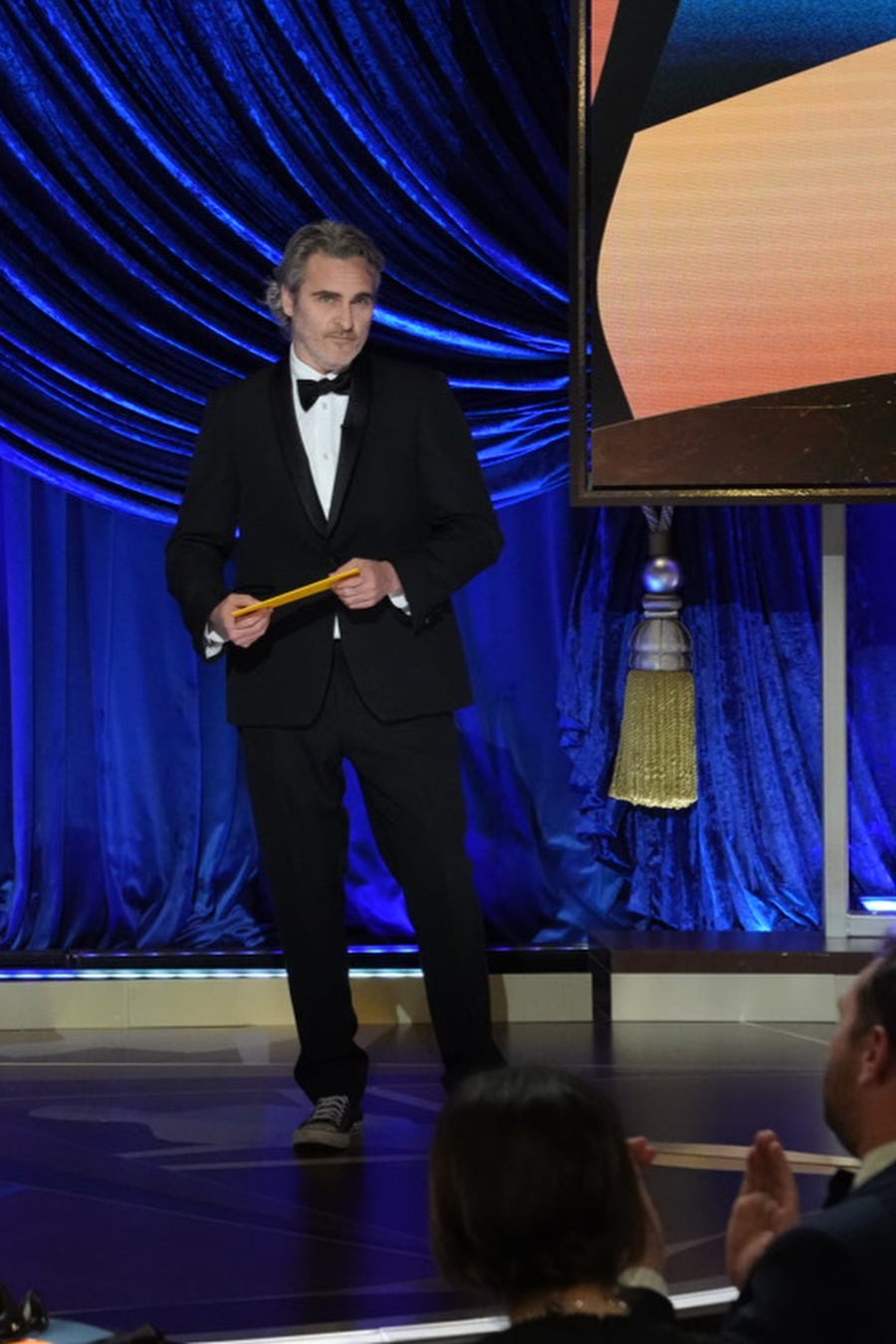 Joaquin Phoenix presents the award for best actor.