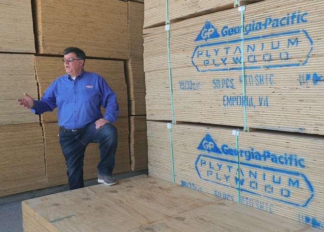 Graves Lumber Co. President Ed Belair talks Tuesday in Copley about the rising costs of building materials.