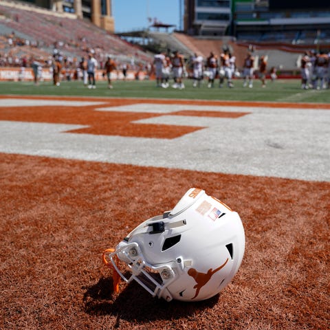 A Texas helmet lays on the field after the Orange-