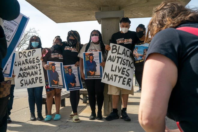 Armani Sharpe, 20, second in line from right, takes a group photo with family and friends at a rally at Hazel Park City Hall on April 27, 2021, in Hazel Park. The event was held by various disability rights organizations to protest charges filed against Armani Sharpe, who has autism, after two white women approached him demanding to know why he was walking in their neighborhood, according to a joint news release by the organizations; Color of Autism and Warriors on Wheels.
