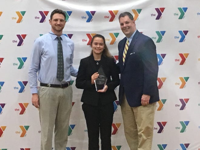Jenna Stilling, center, received the Willis Bradford Christian Leadership Award. She is shown with Steven Clark, left, FCA area representative and David Lewis, right, CEO of the Prattvilel YMCA