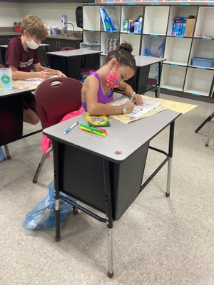 DeSoto Trail fifth grader Victoria Whitney uses supplies from her art bag.