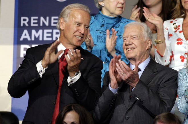 FILE - Former President Jimmy Carter, right, is seen with Democratic vice presidential candidate Sen. Joe Biden, D-Del., at the Democratic National Convention in Denver, Tuesday, Aug. 26, 2008. (AP Photo/Paul Sancya)