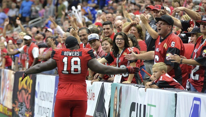 Jacksonville Sharks lineman Keith Bowers (18) celebrates with fans after defeating Columbus for the National Arena League title in 2017.