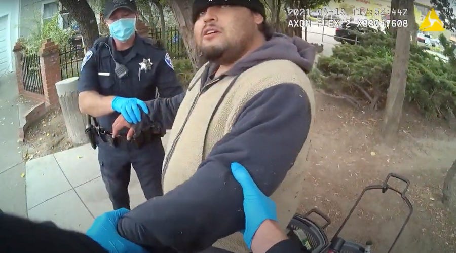 Police officers are pictured attempting to take Mario Gonzalez, 26, into custody in Alameda, California, last week. The video goes on to show officers pinning Gonzalez to the ground during the arrest that ended in his death.
