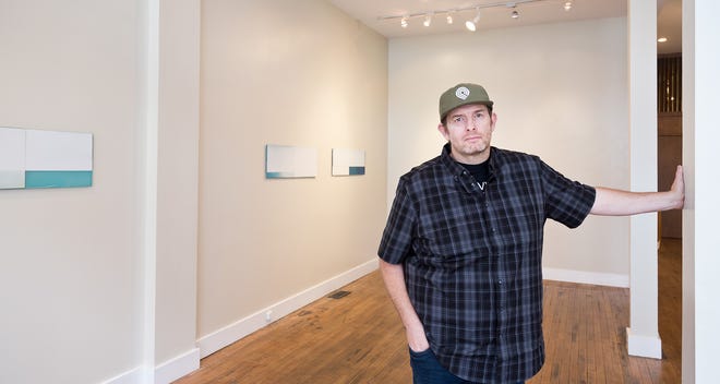Jeffrey Cortland Jones photographed with art from his solo exhibition, "Landscape Replica (Long Walks and Blue Eyes),” at Sarah Gormley Gallery in the Short North.