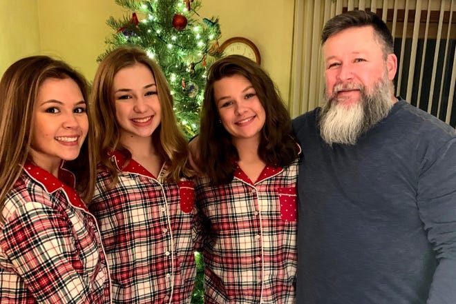 Chuck Robertson and his three daughters: Sophia, Allie and Faith.