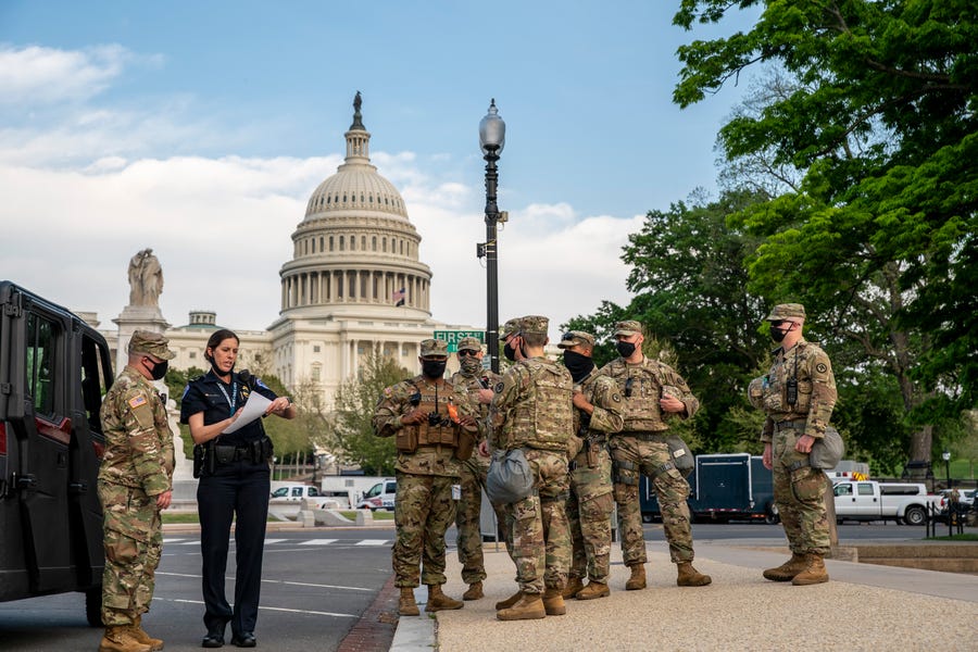 Military personal and Capitol Hill Police department stage outside the US Capitol before U.S. President Joe Biden will address a joint session of Congress in the House chamber of the U.S. Capitol.