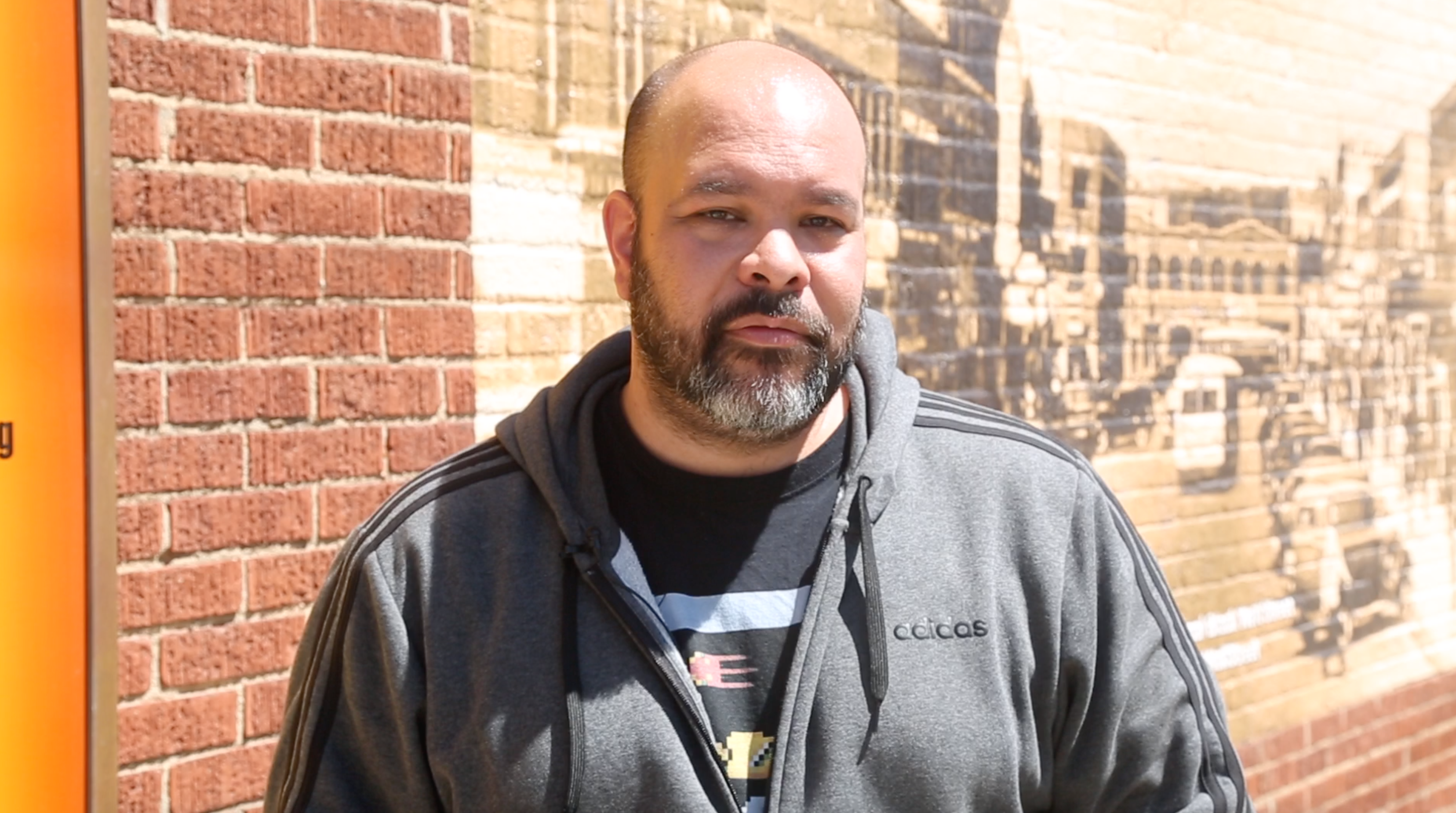 Carlos Moreno, author of "The Victory of Greenwood," stands on the corner of Greenwood Avenue and Archer Street talking about the 1921 Tulsa Race Massacre.