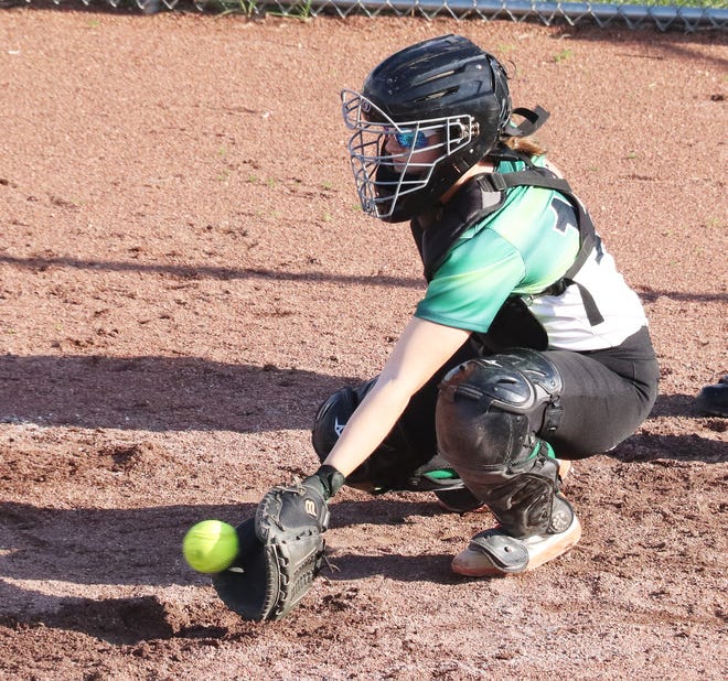 Dwight catcher Alexis Thetard snares a low pitch during the Trojans' softball contest with Morris on Thursday.