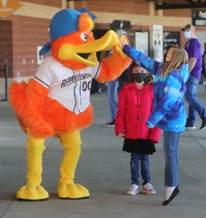 Akron RubberDucks mascot Webster gets a high-five from Miley Siers, 8, right, and her sister Ana, 7, of Akron, during an open house for season pass holders May 1 at Canal Park in Akron.