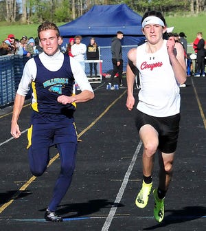 Hillsdale's Mason Myers, left, and Crestview's Tanner Moore race toward the finish line during the 100 dash Friday at the Mapleton Night Invitational.