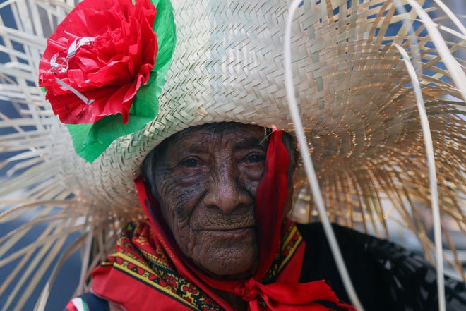 A woman dressed as a revolutionary Zacapoaztla indigenous soldier poses for a picture during a reenactment of The Battle of Puebla, May 5, 2019, between the Zacapoaztlas and French army as part of Cinco de Mayo celebrations in the Penon de los Banos neighborhood of Mexico City. Cinco de Mayo commemorates the victory of an ill-equipped Mexican army over French troops in Puebla on May 5, 1862.