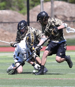 Iona's Louis Varsames (18) and Jackson Shafiroff (29) put pressure on Saint Anthony's Ryan Baudo (11) during lacrosse action at Iona Prep in New Rochelle May 1, 2021. Saint Anthony's won the game 14-8.