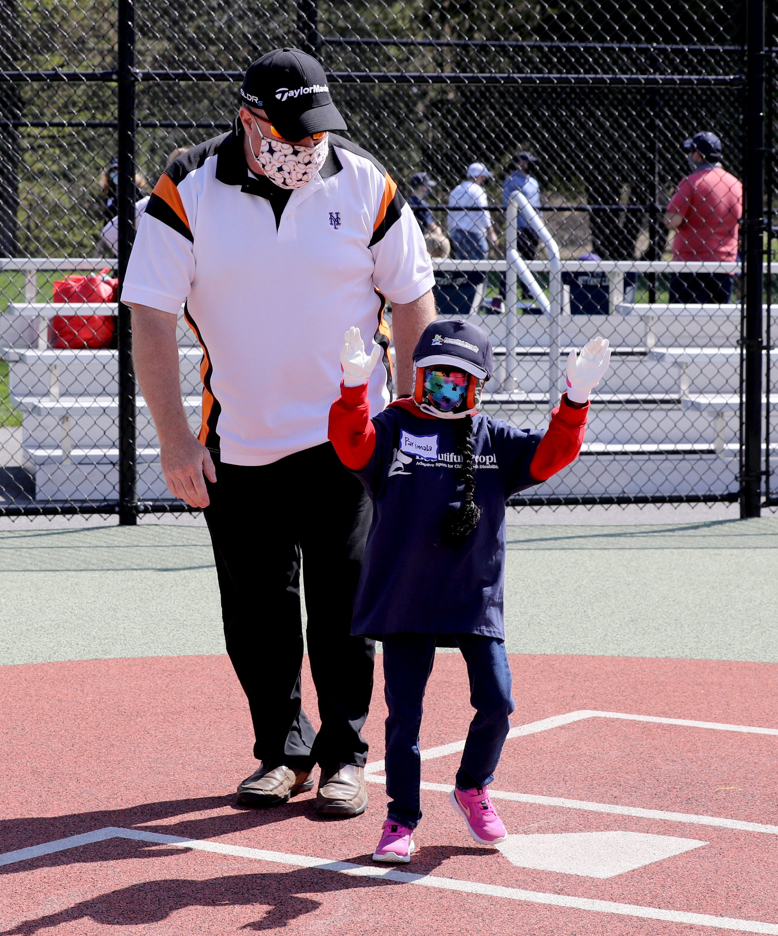 Parimala Cosgrove, 11, of Grahamsville, N.Y. celebrates after scoring a run she plays baseball during opening day for Beautiful People Baseball in Warwick, N.Y. May 2, 2021. The baseball program is one of the sports offered by Beautiful People, which provided adaptive sports for children with disabilities. 