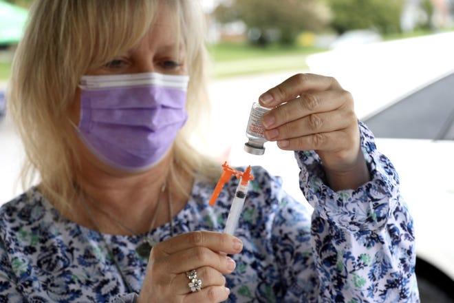 Susan Klingaman, a nurse with Penn State Health Medical Group, prepares a Moderna vaccine at the York County Food Bank on Monday, May 3, 2021. Tina Locurto photo.