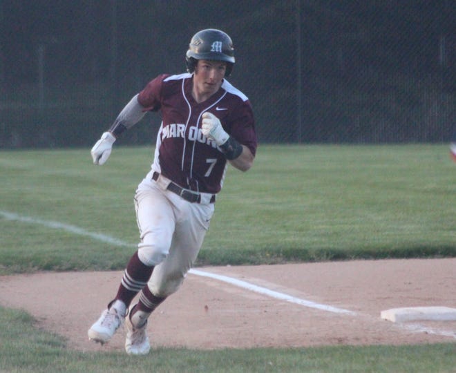 Holland Christian's Kaden Shook rounds third base in a game against West Ottawa