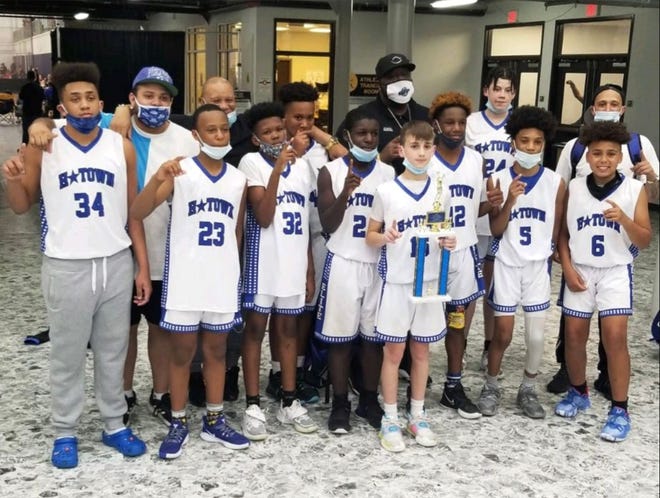 The H-Town Elite seventh-grade boys basketball team poses for a photo after winning the May Mayhem Classic 13U title