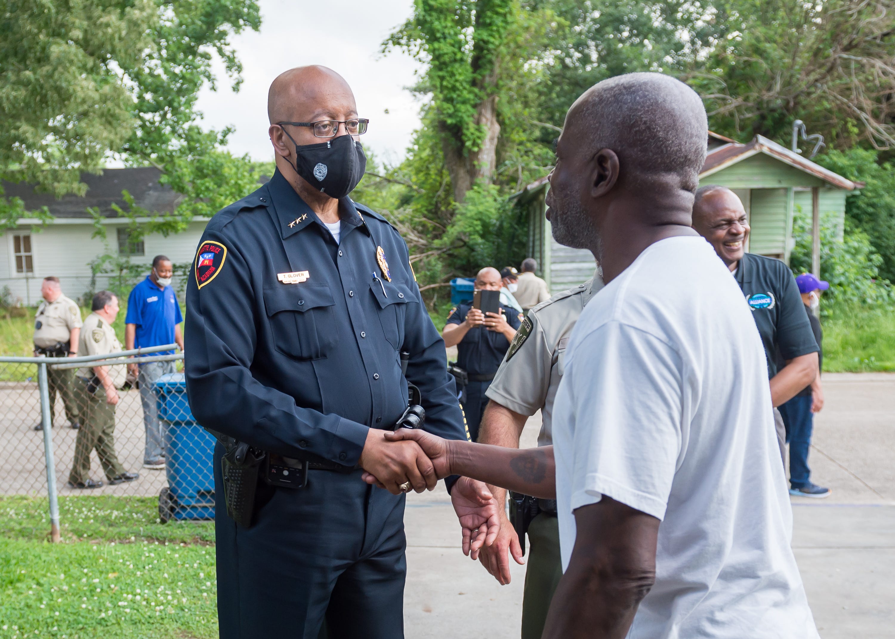 Law Enforcement Officers with the Lafayette Police Department, Lafayette Parish Sheriff's Office and the Lafayette City Marshal's Office walk in a neighborhood to visit with residents, listen to any concerns and introduce themselves as part of an ongoing effort to bridge the gap between law enforcement and the community, Monday, May 3, 2021.