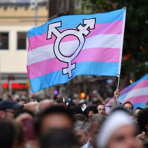 People display transgender pride outside the Stone
