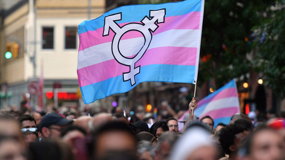 People display transgender pride outside the Stonewall Inn during a rally June 28, 2019, to mark the 50th anniversary of the Stonewall Riots in New York. On soccer fields, in locker rooms and even at the doctor's office, the rights of transgender youths have become a political lightning rod as dozens of bills attempt to dictate their fate in conservative states.
