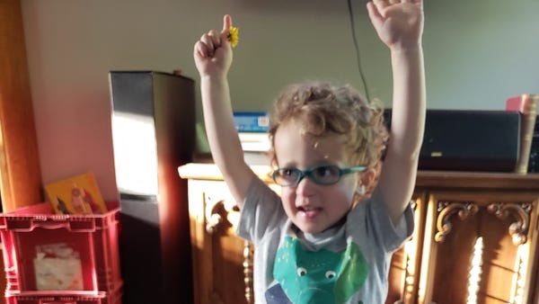 2-year-old Doran stands next to the wooden barrel 