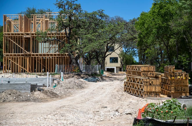 Crews work on a town home project on West Alpine Road in Austin last month. The City Council is considering increasing the city's homestead exemption for property owners from 10% to 20%.
