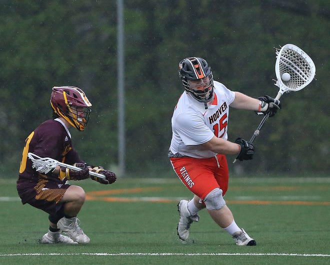 Hoover goalie Austin England moves the ball out of Hoover  goal territory with defense from Drew Mercurio of Walsh Jesuit. 