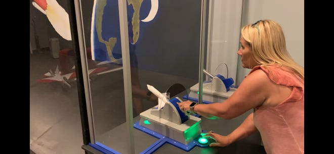 Michelle Smith, operations director at the Science & Discovery Center of Northwest Florida in Panama City, demonstrates a new "rocket to the moon" activity.