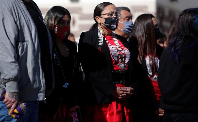 FILE - Oneida Nation holds a tobacco-burning and smudging ceremony May 5, 2021, on the Oneida Casino property after a shooter killed two people and injured a third on May 1, 2021, in Ashwaubenon, Wis. A walk to bring awareness to Missing and Murdered Indigenous Women, represented by the color red, was held after the ceremony. May 5 was also MMIW Awareness Day in Wisconsin.