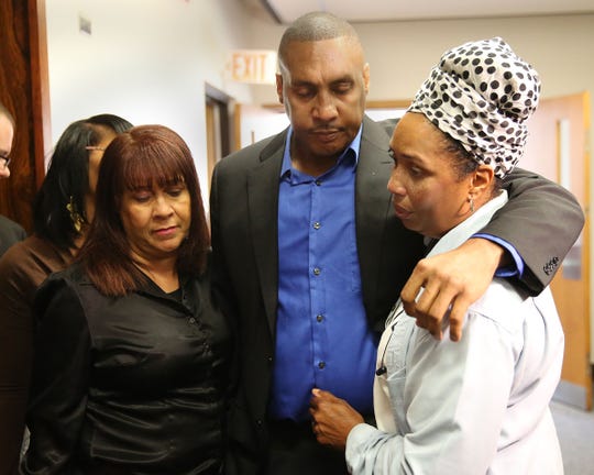 Claude Motley, center, is surrounded by his sisters after the sentencing of Nathan King on July 16, 2015. King, 15, himself paralyzed from a shooting, was sentenced to prison for shooting Motley in an attempted carjacking. The case, and Motley's journey, are the focus of a new documentary, "When Claude Got Shot."