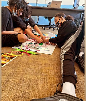 Students work on a design project with pipe cleaners at Academia del Pueblo. The four-tiered course teaches students about history, design and the environment to help them envision their own ideas for the community