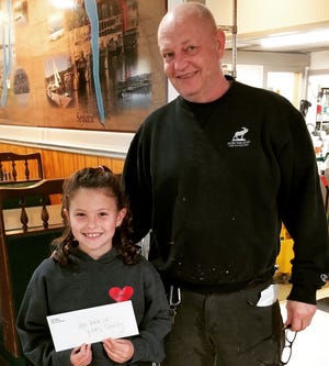 Eight-year-old Kira Christensen and Wagner Restaurant owner John Pallar presented their check for $4,300 to the Hope Walk of Yates County, knowing that all funds raised in Yates County will stay in Yates County.