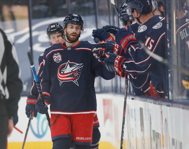Columbus Blue Jackets right wing Oliver Bjorkstrand (28) gets high fives from the bench after scoring a goal during the second period of the NHL hockey game against the Nashville Predators in Columbus on Wednesday, May 5, 2021. 