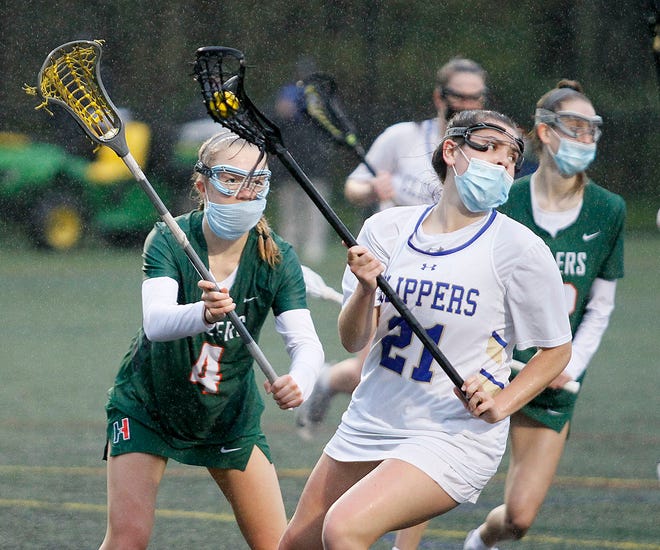 Norwell's Allie Connerty looks for a teammate to pass to under pressure from Hopkinton's Tiffany Mikulis. Norwell High girls lacrosse hosts Hopkinton on Wednesday, May 5, 2021.