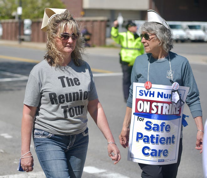 Laurie Ducharme of Leominster and Jeanne Donahue of Hubbardston wear their original vintage nursing caps while walking the picket line outside St. Vincent Hospital Thursday.