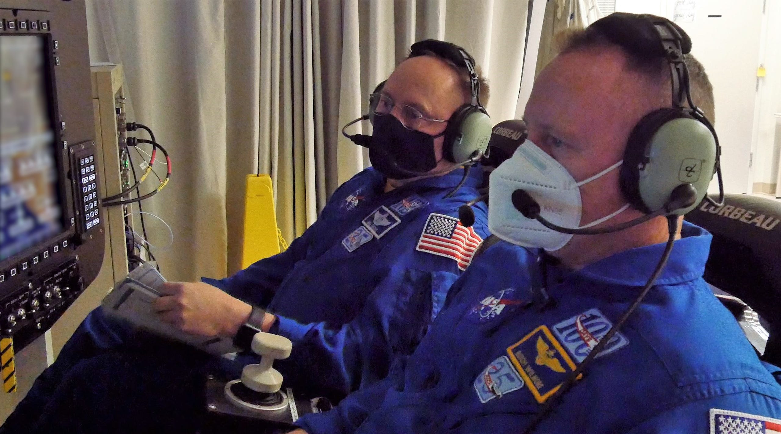 NASA astronauts Barry “Butch” Wilmore and Mike Fincke, who will fly aboard Starliner’s Crew Flight Test mission, monitor the launch portion of Boeing’s simulated Orbital Flight Test-2 mission.