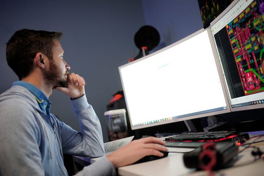 Brandon Schrieber, founder of Leviathan Aquarium and Automation, works on a circuit board design at his home in Halls, Tenn.