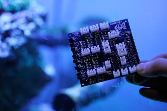 Brandon Schrieber holds one of his Leviathan Aquarium and Automation circuit boards.