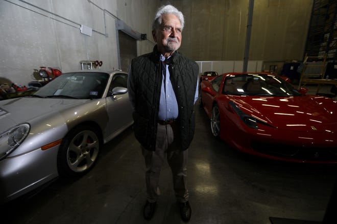 President, Founder and CEO of  FileBank, Gregory E. Copeland, is shown as he poses between a Porsche Turbo and a Ferrari, at his Oakland facility.  Cars make up just a small amount of the items his company keeps in storage.  Wednesday, May 5, 2021