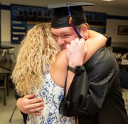 Brandon Zimmermann gets a hug from his mom, Nadine, after graduating from Universal Technical Institute in Avondale and getting a surprise job offer.