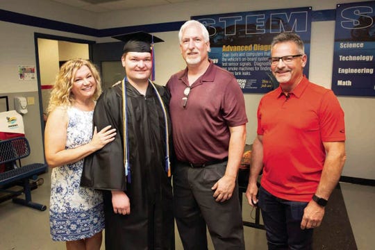 Graduate Brandon Zimmermann with his parents, Nadine and Paul, and Fritz Pfauth, regional service manager at Sunstate Equipment, at graduation at Universal Technical Institute in Avondale on April 23, 2021.