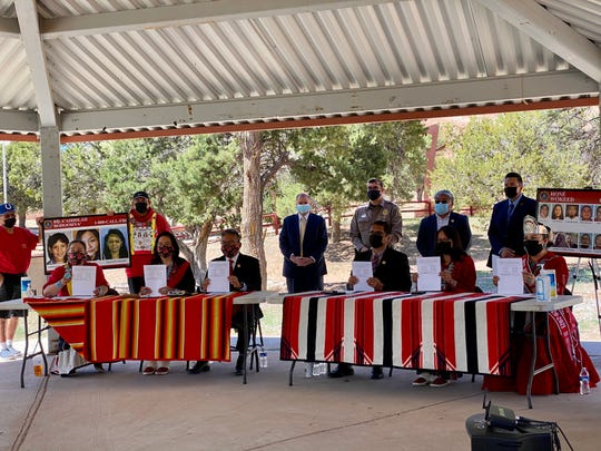 Navajo leaders alongside FBI officials hold up the signed proclamation marking May 5 as Navajo Nation Missing and Murdered Indigenous People’s Day. Tribal leaders signed the proclamation in Window Rock on May 5, 2021.