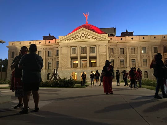 The Arizona state Capitol is lit up red at dusk for Missing and Murdered Indigenous People Awareness Day on May 5, 2021.